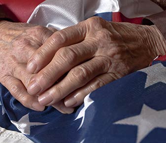 Older Hands on American Flag